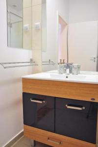 a bathroom with a sink and a mirror at HOGOR Apartments in Sibiu