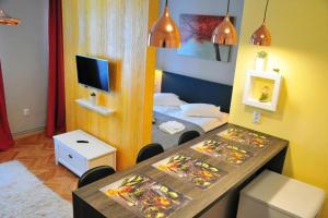a room with a bedroom with two beds and a table at HOGOR Apartments in Sibiu