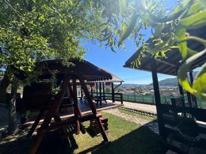a gazebo with a roof on the grass at Casa Alexana in Gura Humorului +13 photos