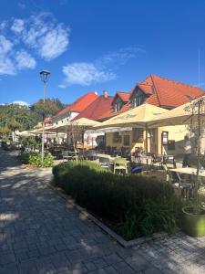a patio with tables and chairs and umbrellas at Apartman Bojnice Kúpele in Bojnice