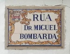 a sign on the side of a building at Yellow House in Tavira