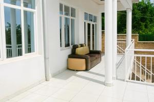 a couch sitting on a porch with windows at Park View Perch Guest house with Balcony near Downtown in Kigali