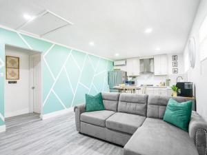 a living room with a couch and a kitchen at Dora's Haven Getaway-Cozy 1Bedroom with Boat or Camper Parking- Free in Mount Dora