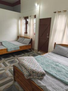 Postel nebo postele na pokoji v ubytování Sirful Homestay + 11 fotografií