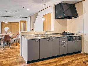 a kitchen with a sink and a counter top at 美祢Terrace in Mine