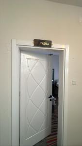a white door with a sign on top of it at Zaloğlu Oda in Midyat