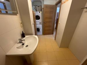 a bathroom with a sink and a washing machine at Apartamento Bolboreta Playa Rodeira in Cangas de Morrazo +22 photos