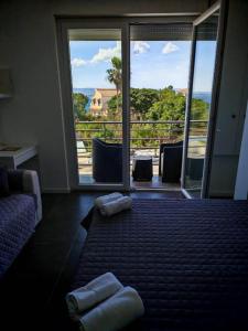 a room with a large window and two towels on the floor at Villa Plemmirio Reserve in Plemmirio +36 photos