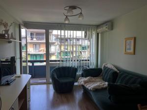 a living room with a couch and chairs and a window at Atgaiva in Palanga