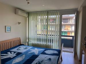 a bedroom with a bed and a sliding glass door at Atgaiva in Palanga