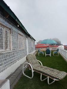 a bench sitting on the grass next to a building at White Bird Villa in Khaira Gali +7 photos