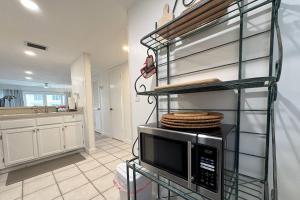 a kitchen with a microwave on a rack with towels at Pier Point 17 in St. Augustine +41 photos