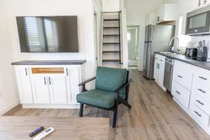 a kitchen with a chair and a refrigerator at Oceans RV Resort in Holly Ridge +6 photos