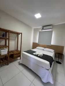 a bedroom with a bed with two towels on it at Flats Ana Alves Residence Delta do Parnaíba- Piauí in Parnaíba