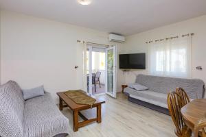 a living room with a couch and a table at Apartments with parking space Srima - Vodice, Vodice - 23593 in Srima