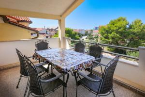 a patio table and chairs on a balcony at Apartments with parking space Srima - Vodice, Vodice - 23593 in Srima