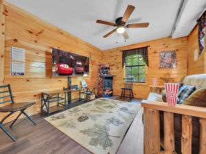 a living room with wooden walls and a ceiling fan at The Eagle's Nest Mountain Cabin Gatlinburg in Gatlinburg +21 photos