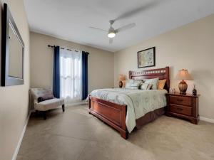 a bedroom with a large bed and a chair at Mountain View #312 Surprise in Surprise +25 photos