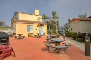 a group of picnic tables and benches in front of a building at Pacific Plaza #305 - Shore Thing - BdrmD-K in Oceano