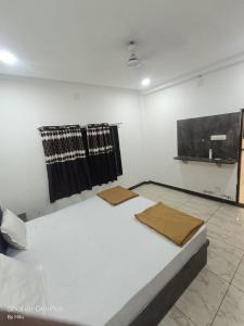 a bedroom with a bed in a room at Kuber palace in Dwarka