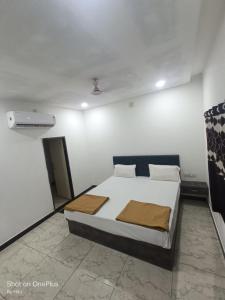 a bedroom with a bed in a room at Kuber palace in Dwarka
