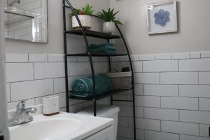 a bathroom with a black shelf over the toilet at One bedroom condo close to H St in Washington +29 photos