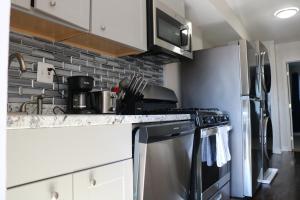 a kitchen with a stove and a microwave at One bedroom condo close to H St in Washington