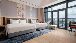 a hotel room with two beds and a large window at Holiday Inn Express Haikou Int'l Duty Free City by IHG in Haikou +42 photos