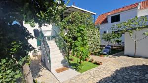 a house with a staircase and a fence at Holiday house with a parking space Jadrija, Sibenik - 24931 in Jadrija