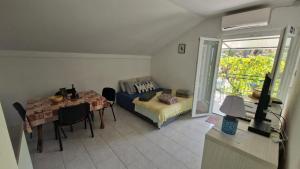 a living room with a couch and a table at Holiday house with a parking space Jadrija, Sibenik - 24931 in Jadrija