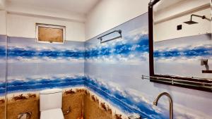 a bathroom with a mural of clouds on the wall at D n A secret Palace in Tangalle +23 photos