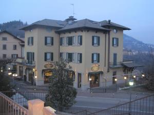 a large building in front of a building at Hotel Residence Moderno in Selvino