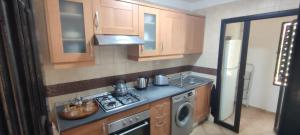 a small kitchen with a stove and a sink at Atlas Golf Resort - Marrakech palmeraie a 6 k m du centre in Marrakesh