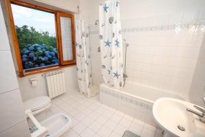 a bathroom with a toilet and a sink and a shower at La Campagna nel Borgo in Capodimonte +24 photos