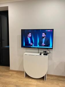 Un televisor de pantalla plana colgado en una pared blanca en Okie-Dokie, en Dilijan