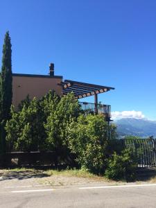 a building with a deck on the side of a road at La Perla del Lago di Como - CIR O97O67 in Perledo
