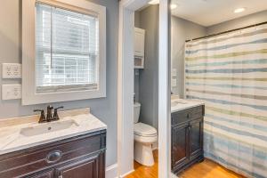 a bathroom with a sink and a toilet and a window at Fish, Swim and Grill Lakefront Carolina Home! in Lake Waccamaw +28 photos