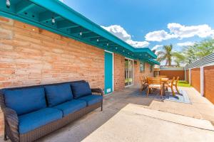 a couch on a patio with a table and chairs at Full Triplex In Central Tucson Ev Charging in Tucson