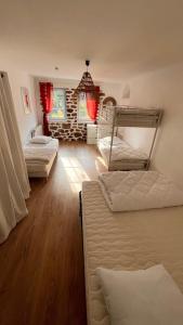 a bedroom with three bunk beds and a fireplace at Grande maison avec piscine 13 couchages proche Paris in Rebais