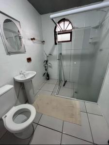 a bathroom with a shower and a toilet and a sink at Hostel Boa Vista in Joinville +25 photos