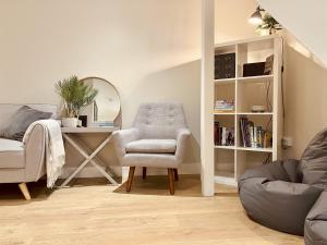 a living room with a chair and a desk at The Light Keepers Retreat in Cromer