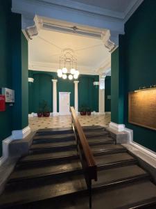 a church aisle with a bench and a chandelier at Cosy County House apartment with free private parking Sleeps up to four guests in York +4 photos