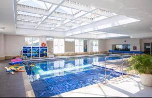 a large swimming pool with a large ceiling at Flat em Alphaville Hotel in Barueri