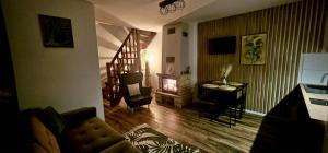 a living room with a couch and a fireplace at Bezdroża Mazurskie in Mrągowo