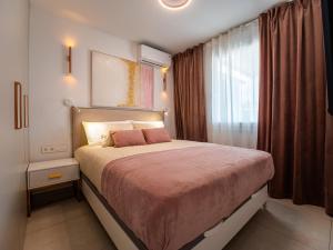 a bedroom with a bed and a window at Deluxe Atico Puerto de la Cruz in Puerto de la Cruz