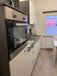a kitchen with a stove top oven in a kitchen at Sweet Home Appartements 2 in Bottrop