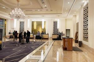 a lobby with people in a building with a chandelier at Five Star Trump Hotel No Resort And Cleaning Fees in Las Vegas +75 photos