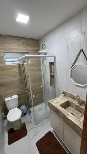a bathroom with a shower and a toilet and a sink at Casa Almar Carapibus in Conde +11 photos
