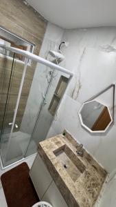 a bathroom with a sink and a shower at Casa Almar Carapibus in Conde