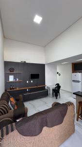 a living room with a couch and a tv at Casa Almar Carapibus in Conde